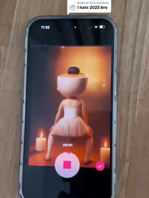 The cover image shows a phone displaying a video of an animated figure dressed as a ballerina dancing. The phone is held against a wooden background. The video within the phone shows a 3D animated figure with a large head mimicking a ballerina, set against a background with candles and warm lighting. The phone's display is overlaid with playback controls. In the top left corner, a comment bubble shows another user's comment. There is a warm, golden color palette.