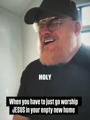 A man in a black shirt, black cap and glasses is featured, laughing with his mouth open.  The word "HOLY" is in bold white text at the top of the image. Below this is a black bar with white text explaining the video content.