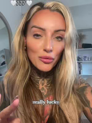 A woman with blonde hair and tattoos on her neck and arm is looking at the camera. Text overlays include the number 777 with two heart emojis and "really lucky".