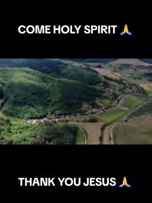 The cover image displays an aerial view of a landscape with rolling green hills, a winding road, and a few scattered buildings. The image is framed in black with the white text overlays “COME HOLY SPIRIT” at the top and “THANK YOU JESUS” at the bottom. Both text overlays are accompanied by a praying hands emoji.