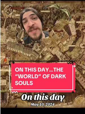 The cover image shows a man's face over a map of a video game world. A red bar at the bottom displays the text: "ON THIS DAY...THE 'WORLD' OF DARK SOULS" and a date. The background map has multiple buildings drawn onto it, and there is a Dark Souls logo at the top.