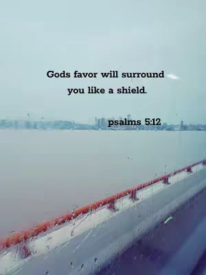 A serene landscape shot featuring a body of water in the foreground with a cityscape visible in the mid-ground under an overcast sky. The image is overlaid with inspirational text in black, emphasizing themes of faith and protection. The overall tone is calm, with muted colors.
