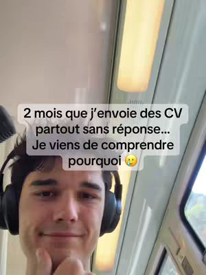 A young man with dark hair and headphones is inside what appears to be a train or subway. The background is a blurred view of the interior, with overhead lights visible. Overlayed in clear, white text on the image is a statement about sending out CVs and a question of why there has been no response. The man has a slight smile, with a questioning expression, as if he is considering something.