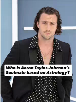 The cover image features a medium shot of a man, Aaron Taylor-Johnson, with a white box containing text overlaid at the bottom. He is the central focus, with a slightly upward gaze conveying curiosity or thoughtfulness. He wears a black blazer over a black shirt with white polka dots and a subtle gold necklace. The background features a light blue background, and a glimpse of the edge of a wall.