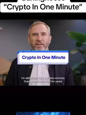 The cover image features a man centered, speaking. Above him, is a graphical white text box that states "Crypto In One Minute". He appears to be in a professional setting, with a neutral background and a subtle green plant. The title graphic and text overlay establish the theme of the video.