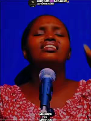 A cover image featuring a woman with her eyes closed, singing into a microphone in a studio setting. The woman is wearing a floral top. The background is a gradient of deep blue. Text overlays are present at the top and bottom of the image.