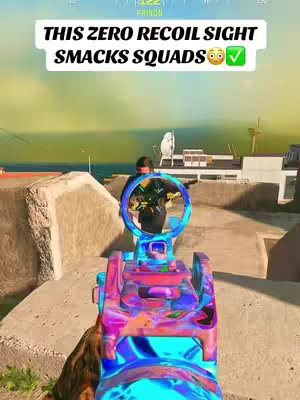 The image is a first-person view from a video game, with a colorful gun sight in the foreground. The background shows a cityscape set in what appears to be a sunny outdoor environment. Text overlayed on top declares the sight's effectiveness.