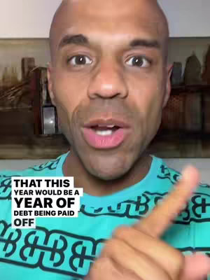 A close-up shot of a bald, dark-skinned man with an open mouth, seemingly mid-sentence. He is wearing a teal patterned t-shirt. Overlaid on the image is a white text box with black text.