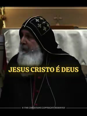 Image features a man in a black hooded garment with a white beard, set against a light-colored background. The text overlay reads 'JESUS CRISTO É DEUS' in a yellow, stylized font.