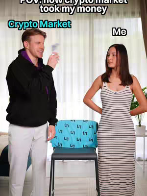 The image is a meme-style shot set in a domestic environment. On the left, a man in a black hoodie and white pants holds up what appears to be money, seemingly happily. On the right, a woman in a striped dress stands with her hands at her waist looking displeased. A blue towel is draped over a chair in the middle. Text overlays identify them as the 'Crypto Market' and 'Me,' respectively, with additional text indicating the perspective: 'POV: how crypto market took my money'.