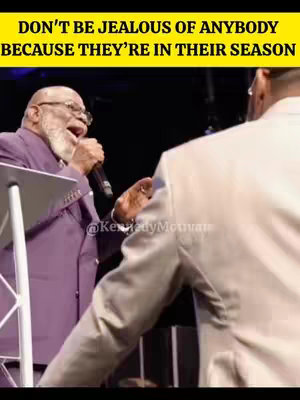 A scene of a man in a purple suit speaking into a microphone, and another man wearing a white jacket is listening. Text over the image urges viewers not to be jealous of others.