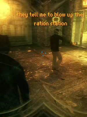 An image from a video game featuring a dimly lit, gritty interior. In the foreground, a dark figure and in the background, a person in civilian clothing walks toward the right of the frame near a metal gate. A yellow text overlay reads, "they tell me to blow up the ration station".