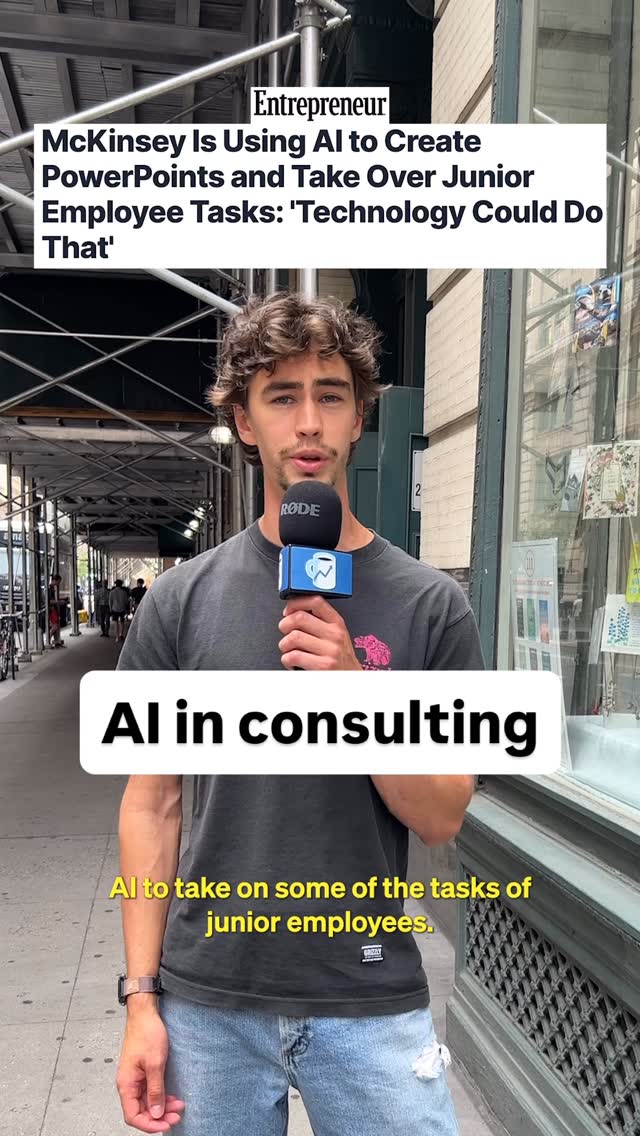 A man with curly hair holds a microphone in front of an urban street. The background includes buildings, scaffolding, and other pedestrians. The man is wearing a t-shirt, and there is text overlayed on the image.