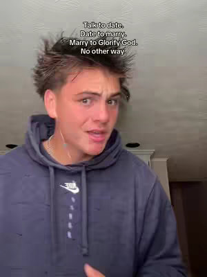 A young man with spiky brown hair is framed from the chest up, slightly angled towards the viewer. He's wearing a dark blue Nike hoodie. Above him, white text conveys a message about life choices.
