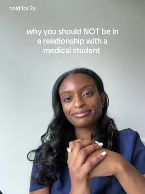 A woman with long black wavy hair is in a medium shot, smiling. The text overlay says "why you should NOT be in a relationship with a medical student". She is wearing a dark blue top and a gold ring. The background is plain.