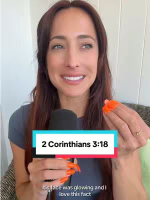 A woman with auburn hair is holding a microphone and gesturing with her hand. Text overlaid on the image reads \"2 Corinthians 3:18\".
