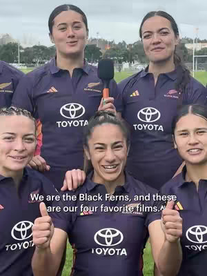 A group of women in matching dark blue and orange rugby jerseys are smiling at the camera and giving a thumbs-up. Behind them is a green field and overcast sky. Text at the bottom states "We are the Black Ferns, and these are our four favorite films."