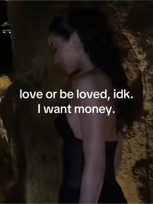 A woman in a black dress, seen from the side, leans towards the left with a blurred natural background. The backdrop seems to consist of rock formations, illuminated with a warm, ambient light creating a contrast with the dark outfit. Above the woman, centrally positioned text phrases are written in a white or light-colored font: