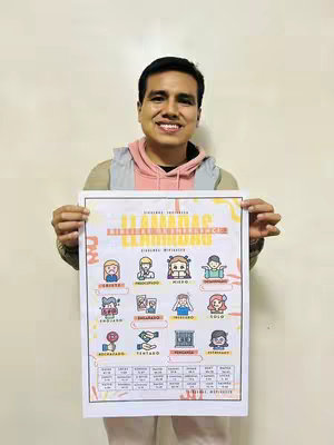 A man smiling, holding a colorful poster with illustrated icons and text. The poster contains images related to emotions.