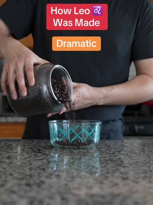 A person is pouring coffee beans from a glass jar into a patterned glass bowl. Text overlays read: "How Leo ♌ Was Made" in a red rectangle, and "Dramatic" in an orange rectangle.