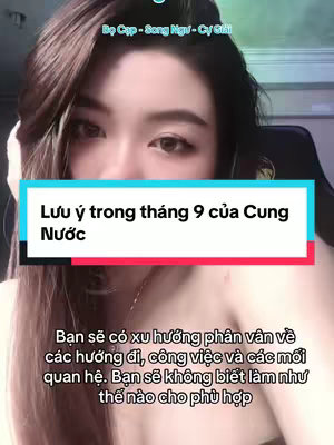 A young woman is the main subject, shot from the chest up, with her face centered. She has long dark hair. The background appears to be an area with a black chair The video includes text overlays in Vietnamese.