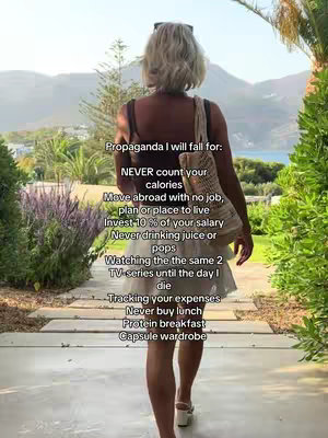 A woman, viewed from the back, walks away from the camera along a stone walkway. She is wearing a short white skirt, sandals, and a dark top. She carries a woven tote bag. Text overlays the image with a list of 'propaganda' the creator will fall for.