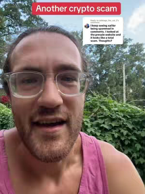 The cover image features a man in the foreground against a blurred outdoor background. He's wearing clear-framed glasses and a pink tank top, looking directly at the camera with a slight smile. Above him is a red rectangular text overlay that reads 'Another crypto scam'. In the upper right corner, a speech bubble displays a user's comment asking for clarification about an xai16r scam. The composition has a straightforward, informative feel with a focus on the man's expression and the overlaid text.