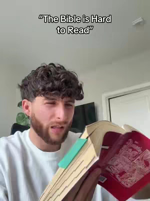 A man with dark curly hair and a beard is holding open the Bible, with a teal bookmark inside. There is text overlayed on top of the image.