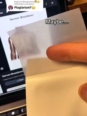 A person's hand is shown peeling back a piece of translucent paper or film, revealing a screenshot of a computer screen. The screen displays a webpage relating to the sternum or breastbone.