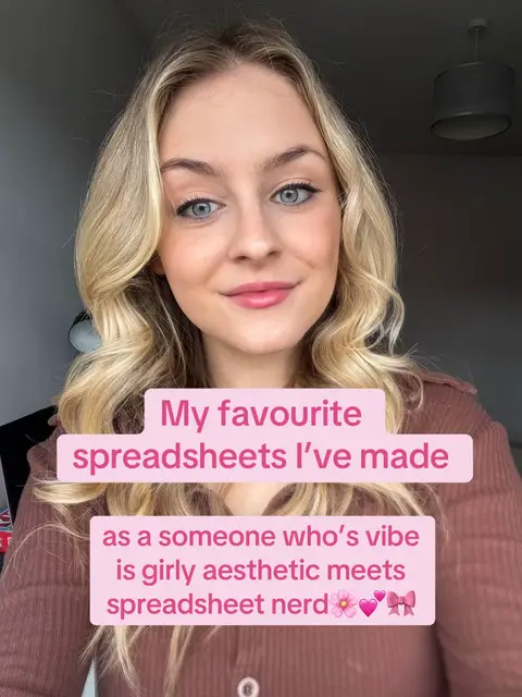 A selfie-style shot featuring a young woman with long, wavy blonde hair and light makeup. She is centered in the frame with text overlaying in a pink box. The background is a blurred indoor setting with a dark ceiling and a blurred light fixture.