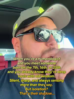 The cover image features a man wearing sunglasses and a baseball cap, positioned from the chest up. He appears to be inside a vehicle, with some of the interior visible. Text overlaid on the image presents a message about numerology and personality traits.