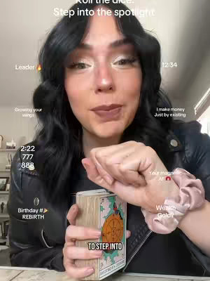 A woman with black hair and expressive makeup is holding a tarot card deck, with overlay text providing information about the video's content.