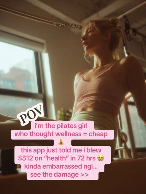 The image is a selfie-style shot taken inside a pilates studio. A blonde woman in a light pink sports bra and light green leggings is positioned to the side, likely on a pilates machine. Overlayed text in a pink and white frame reads "POV", and the rest of the text talks of expenses in health, with an app showing the user they have overspent, creating a humorous or relatable theme. The composition includes a window in the background to the left, with muted colors, and a general sense of studio lighting.