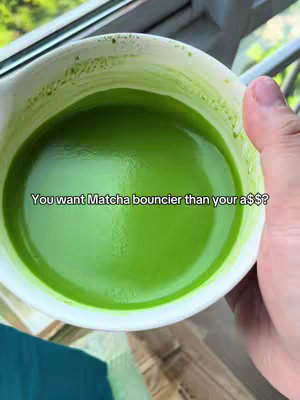 The cover image shows a close-up view of a white ceramic bowl filled with bright green matcha. The matcha has a smooth, foamy texture, and a hand is holding the bowl near a window with a blurry outdoor view. Text overlayed on the image poses a question to the viewer about wanting matcha that is "bouncier".