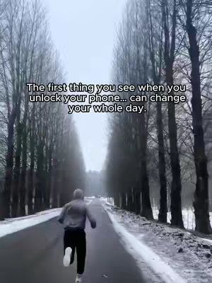 A person runs down a road in a snowy, forested area, with text overlayed on the top. The road stretches into the distance, lined by tall, leafless trees on either side. The sky is overcast.