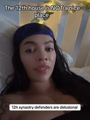 A selfie-style shot with a woman lying in bed. The woman has dark hair and is wearing a blue headscarf. The background is blurry, featuring a white bed sheet and some soft lighting.  The framing is close-up, focusing on her face, with text overlays at the top and bottom.