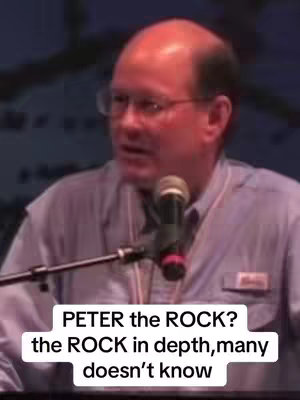 A man with glasses and a blue shirt speaks into a microphone. Text overlays the bottom half: 'PETER the ROCK? the ROCK in depth, many doesn't know'.