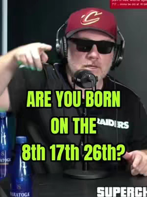 A man wearing a red baseball cap, sunglasses, and headphones is pointing toward the viewer. Text overlays ask a question below his face, with the image appearing to be from a podcast setting, with props like bottled water visible.
