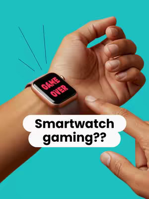 A hand wearing a smartwatch showing a black screen with red text that says "GAME OVER". The hand is positioned in front of a teal background. A white speech bubble with the text "Smartwatch gaming??" is placed below the hand.