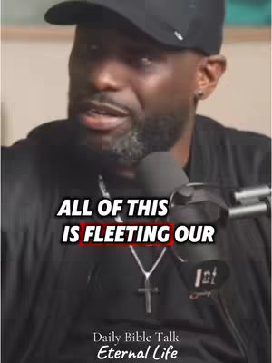 A dark-skinned man wearing a black cap and shirt is centered in the frame. The image is lit with soft light, and the man is positioned in front of a blurred background. Text overlays are present on the image along with text mentioning 'Daily Bible Talk Eternal life'.