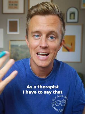 A medium shot features a man speaking, with a blue shirt and blond hair with a slight wave. The background includes a collection of framed artwork, mostly muted tones, and soft lighting. Text overlayed on the bottom of the image states a message.