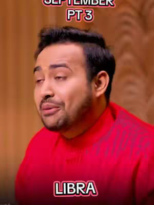 A man in a red shirt is centered in the frame, with text overlays at the top and bottom. The man is looking slightly up and to his left, with a neutral expression. The background is a blurred brown.