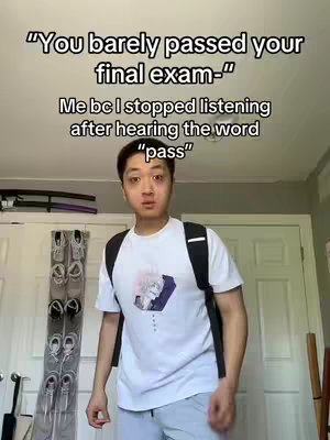 A young man with short black hair is centered in the shot. He's wearing a white t-shirt, a black backpack, and gray sweatpants. Behind him, a gray wall and white door are visible. Above the man is text overlayed on the image.