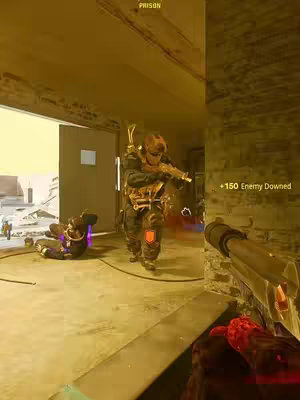 The image captures a scene from a first-person shooter game, possibly in a building. Two figures are visible: one is lying on the floor, and the other is standing and appears to be holding a gun, with the player's gun in the foreground. The setting is dimly lit, hinting at an indoor environment, and the color palette is dominated by muted yellow and brown tones.