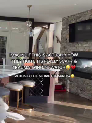 The image captures a well-lit, modern interior with a kitchen island and a stone-clad wall featuring a fireplace. The main text overlay provides context and dialogue, with additional emotional reactions like the teary and broken heart emoji.