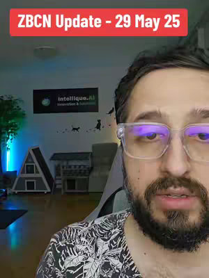 A man with a beard and clear-framed glasses is centered in the frame, looking toward the viewer. Behind him, a room is visible with a sign for Intellique.ai, and some decorative objects. A red text overlay at the top reads "ZBCN Update - 29 May 25."