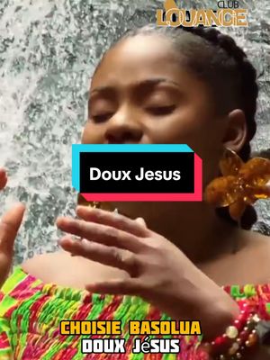 The image features a woman with closed eyes, mid-shot, wearing a colorful top. A text box with the words 'Doux Jesus' is prominently displayed as a hook. The background appears to be a water feature. Other French text is visible at the bottom of the image.