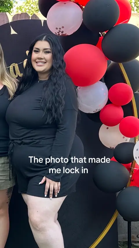 A woman in a black dress is smiling, with balloons in the background. The text "The photo that made me lock in" is overlaid on the image.