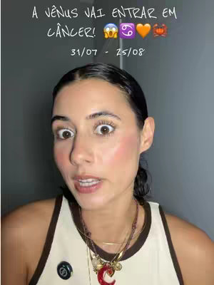 A woman with wide eyes and an excited expression looks directly at the camera. Text overlays the image centered at the top, and she wears a necklace.