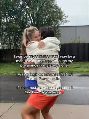 A woman is embraced by a man. She is blonde and has her hair in a ponytail. Text is layered on the image.